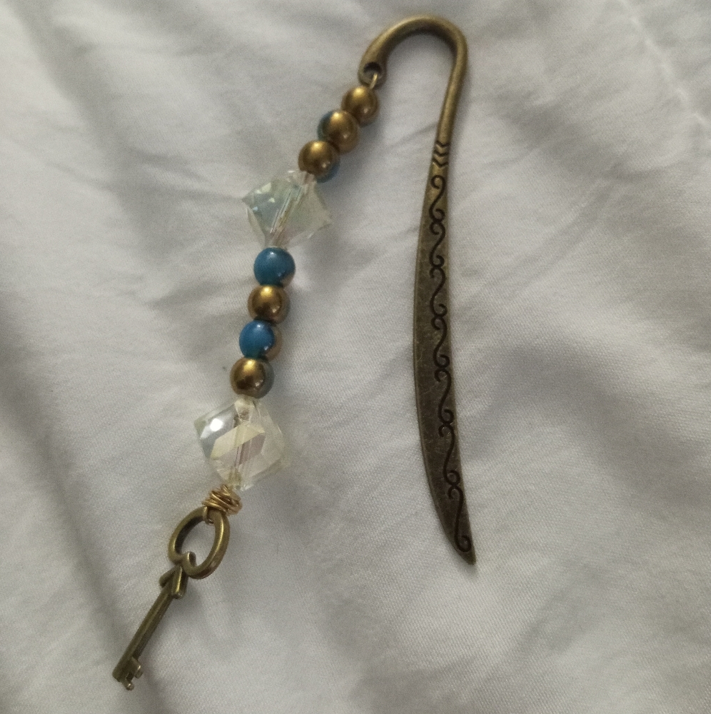 Antique gold filigree crystal bookmark with key logo